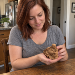 Woman holding the natural cypress wood Laughing Buddha in soft indoor daylight