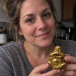 Gold Laughing Buddha Statue held by a woman at home