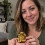 Gold Laughing Buddha Statue held by a woman at home