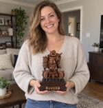 Woman holding the 23 cm resin Laughing Buddha statue with fish pair at home