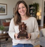 Woman holding the 23 cm resin Laughing Buddha statue on money bag at home