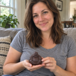 Woman holding the small ceramic Ruyi Laughing Buddha statue at home