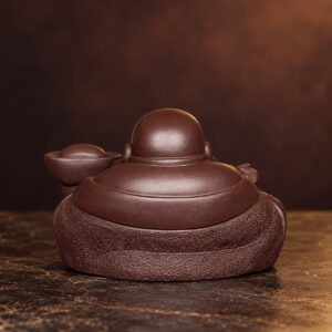 Rear view of the dark brown purple clay Laughing Buddha showing smooth shoulders and textured robe