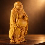 Angled studio view of the cypress wood Laughing Buddha with fan