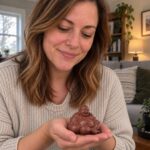 A woman holding the small reddish-brown purple clay Laughing Buddha with soft natural reflections
