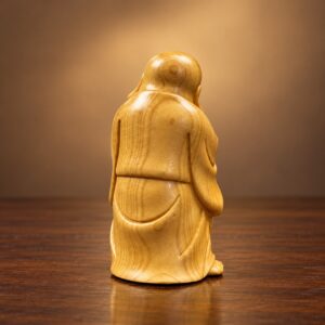 Rear studio view showing the carved robe and natural wood grain of the cypress Laughing Buddha