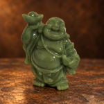 Front studio view of a small green resin Laughing Buddha with one raised ingot and beads