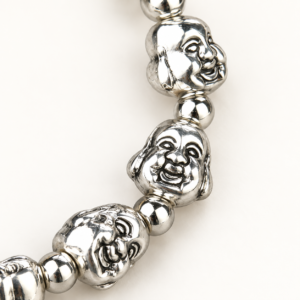 Same-front close detail of smiling Budai face beads and round spacers